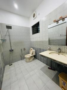 a bathroom with a toilet and a sink at Ayan stay inn in Dargai
