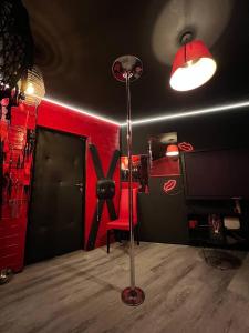 a room with a red wall and a red chair at Lust&Desire BDSM Krakow Apartment in Kraków +17 photos