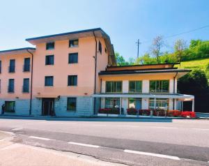 a large building on the side of a street at Albergo Ristorante Bigiù in SantʼOmobono Imagna