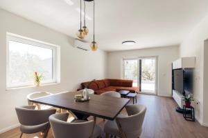 a living room with a table and a couch at Martha's Oliveyard in Biograd na Moru