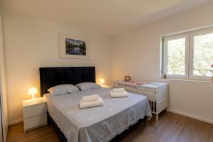 a bedroom with a bed with two towels on it at Martha's Oliveyard in Biograd na Moru +48 photos