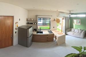 a kitchen with a sink and a refrigerator at Chan Studio Tulum in Tulum