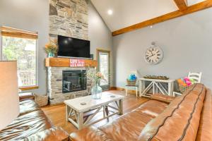 a living room with a couch and a fireplace at Game Room and Hot Tub Spacious Retreat in Hollister in Hollister