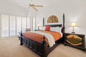 a bedroom with a bed and a ceiling fan at 3rd Hole Hideaway - A Golf Dream at Desert Princess in Cathedral City