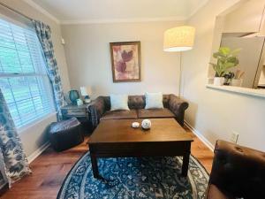 a living room with a couch and a coffee table at Lakefront Condo - King Bed Full Kitchen in Auburn