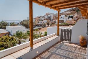 a balcony with a view of a city at Living Blue Tinos in Kardhianí