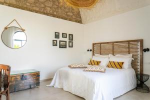 a bedroom with a white bed with a wooden headboard at Dimora Storica Villa Pasquale Capri in Capri