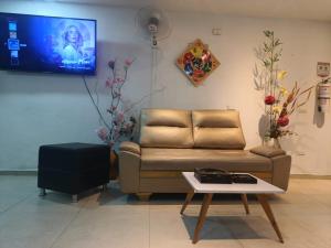 a living room with a couch and a table at HOTEL VITRU in Cúcuta