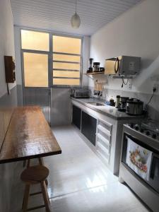 a kitchen with a wooden table and a counter top at Casa Zago 2 in Santa Maria Madalena