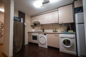 a kitchen with a washing machine and a washer at Las Torres 2 in Calatayud +28 photos