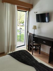 Cama ou camas em um quarto em Hotel Covilhã Jardim