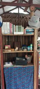 a book shelf filled with books and other items at Eco-Camping Mango Feliz Rincón del Mar in San Onofre +103 photos