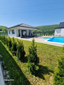 a house with a yard with trees and a swimming pool at Eurouna relax in Bosanska Krupa