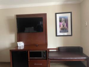 a living room with a tv and a microwave at Forestpark Suites in Cincinnati