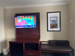 a flat screen tv sitting on top of a entertainment center at Forestpark Suites in Cincinnati