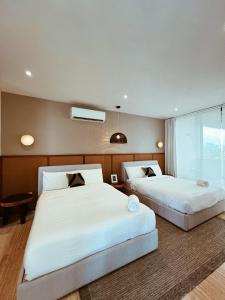 a hotel room with two beds and a window at Penthouse Om in Tulum +26 photos