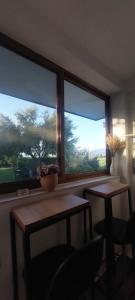 a room with two tables and two large windows at Rustic Tale Guesthouse in Tale +49 photos