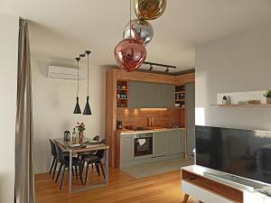 a kitchen with a table and a dining room at Rio Vita with garage parking in Rijeka