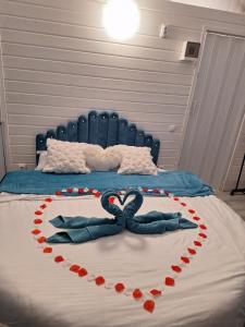 a bed with two swans in the shape of a heart at Igloo Rasnov in Râşnov