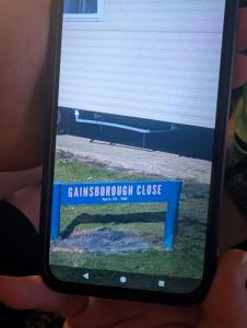 a person holding up a cell phone with a picture at LuKa25 GC080 in Saint Osyth