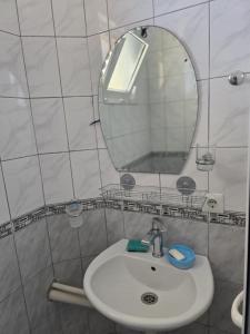 a bathroom with a sink and a mirror at SHARRI Apartments in Ulcinj