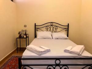 a bedroom with a bed with two towels on it at Luxury Villa Riad Style - WIFI & PARKING in Agadir