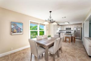 a dining room and kitchen with a table and chairs at Coastal Paradise 5 bedroom retreat with pool spa and a boat lift in Marathon