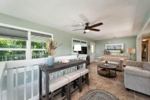 a living room with a couch and a ceiling fan at Coastal Paradise 5 bedroom retreat with pool spa and a boat lift in Marathon