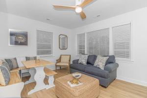 a living room with a couch and a table at Charming 2 bedroom retreat in Myrtle Beach
