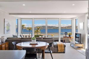 a living room with a couch and a table at Lakeview Retreat With Private Geothermal Pool in Taupo