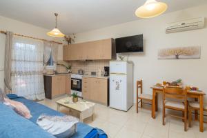 a kitchen and living room with a couch and a table at Estia cozy apartment in Argostoli