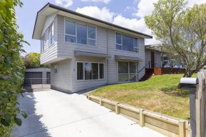 a house with a fence in front of it at Fantail Retreat, Family 4BR Near Lake and Gardens in Taupo