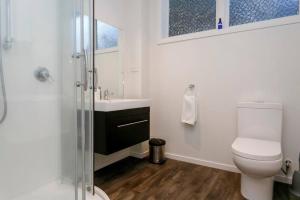 a bathroom with a toilet and a sink and a shower at Taupo Getaway, Private 2BR Apartment With Courtyard in Taupo +7 photos