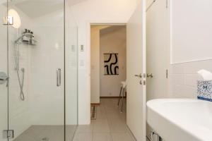 a bathroom with a glass shower and a sink at Huia Haven, Rustic Garden Retreat With King Suite in Taupo +39 photos