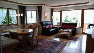 a living room with a couch and a table at "Allgäuglück", Oberstaufen in Oberstaufen