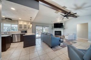 a kitchen and living room with a ceiling fan at Lighthouse Retreat With A Pool in Ponce Inlet