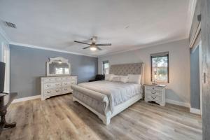 a bedroom with a bed and a ceiling fan at Lighthouse Retreat With A Pool in Ponce Inlet +37 photos