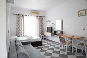 a living room with a couch and a table at NMS Apartments in Ksamil