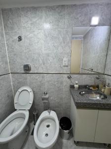 a bathroom with a toilet and a sink and a mirror at Amané - Alquiler temporal con estilo en Posadas in Posadas +8 photos