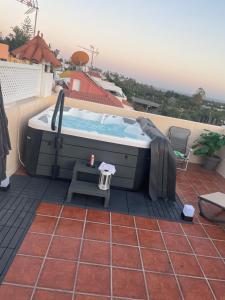 a hot tub on the roof of a house at Basement Apartment Studio in San Bartolomé