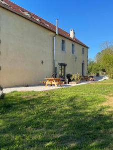 a group of picnic tables in front of a building at L'annexe in Savoisy