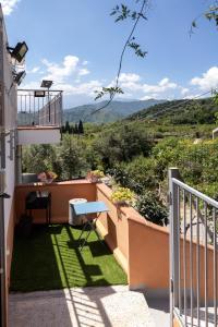 a view from the balcony of a house with a table at Quirin's Apartments in Taormina