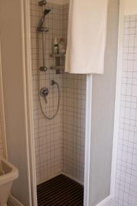 a bathroom with a shower with a black grate at A BeautifuL Terrace on Paradise Imperia - by HOST4U in Montegrazie