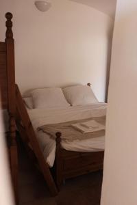 a bedroom with a bed with a wooden frame at A BeautifuL Terrace on Paradise Imperia - by HOST4U in Montegrazie +10 photos