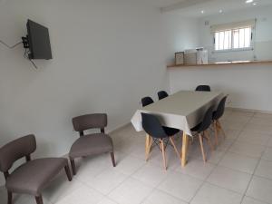 a dining room with a table and chairs at Departamentos Capernaum in Santa Rosa
