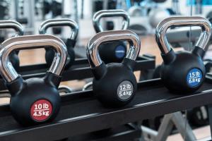 two black dumbbells on a shelf in a gym at Garden Villa Condo at ONE Cable Beach in Nassau