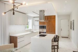 a kitchen with white cabinets and a white counter top at Garden Villa Condo at ONE Cable Beach in Nassau