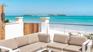 a living room with a couch and a view of the beach at Two Bedroom Condo at One Cable Beach with Patio in Nassau