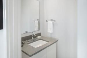 a bathroom with a sink and a mirror at One bedroom condo at ONE Cable Beach in Nassau