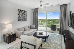 a living room with a couch and a table at One bedroom condo at ONE Cable Beach in Nassau